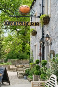 Coach and Horses sign on the front of the pub